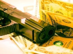 scene of a robbbery with a pistol and dollar bill notes