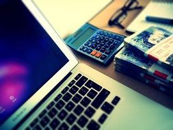 banknotes and laptop on the table