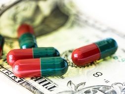 medical pills on the background of money