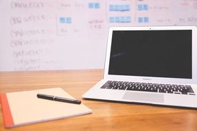 MacBook and notebook on the table