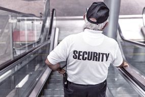 police security on escalator back view