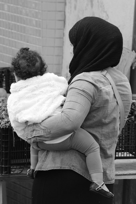 muslim woman with baby in black and white background