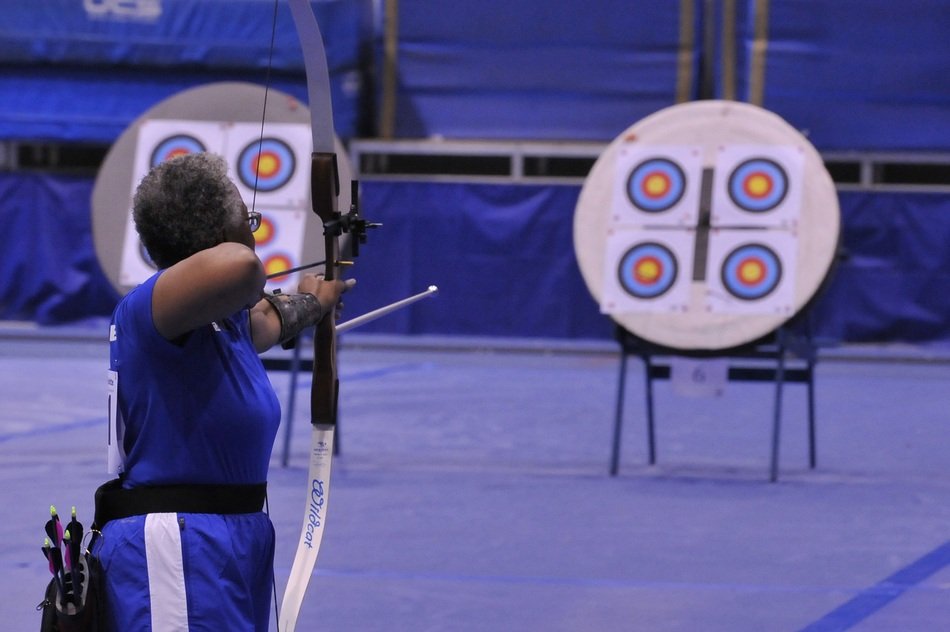 woman with a bow in front of targets