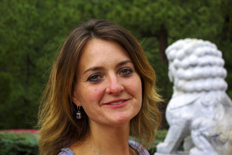 photo of a woman against a stone lion