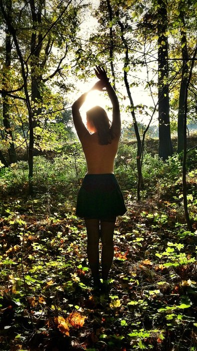 sexy woman in the forest in the bright sun