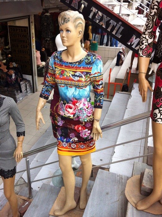 mannequin in colorful dress on stairs