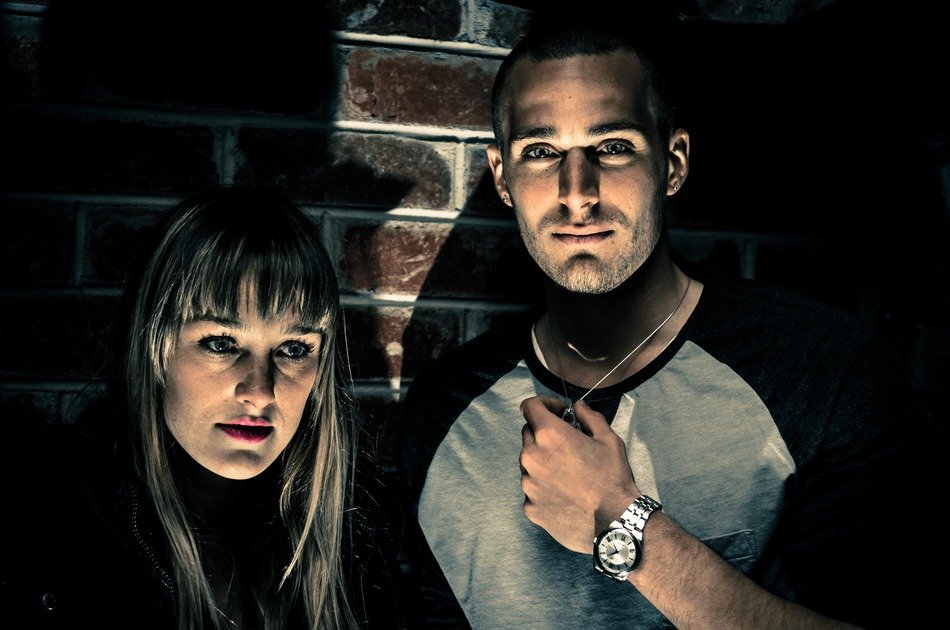 photo of man and woman against the background of a brick wall in a nightclub