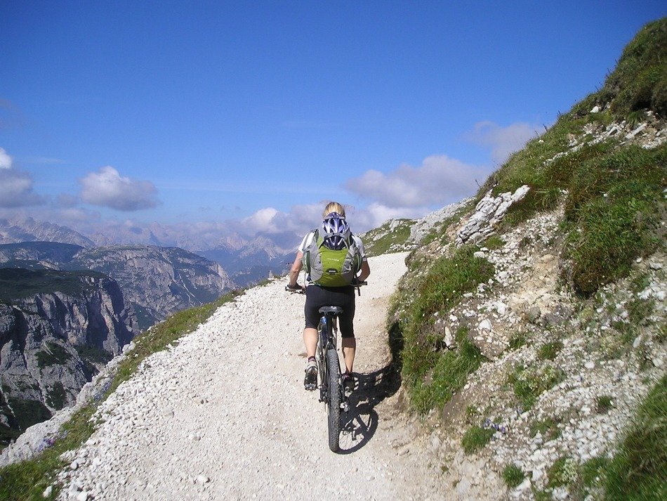Woman is riding on the mountain bike in the Italy