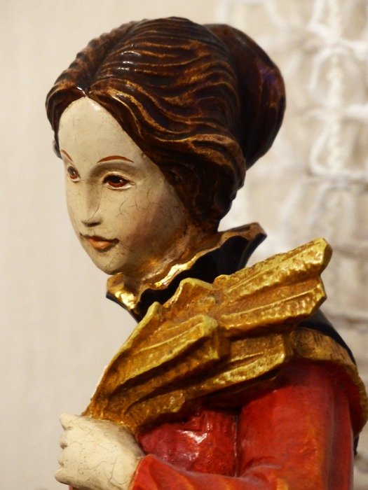 sculpture of a woman with a madonna's head with brown hair