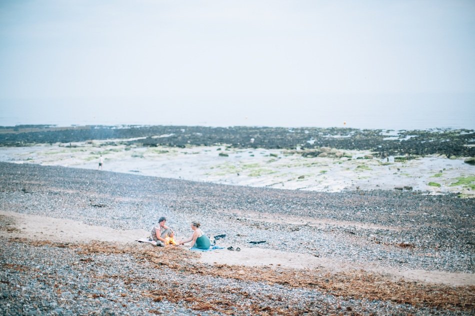 people on the beach among algae