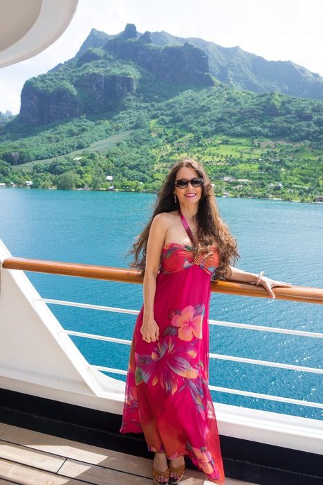 Woman in red colorful dress on ship Mountain Sea view