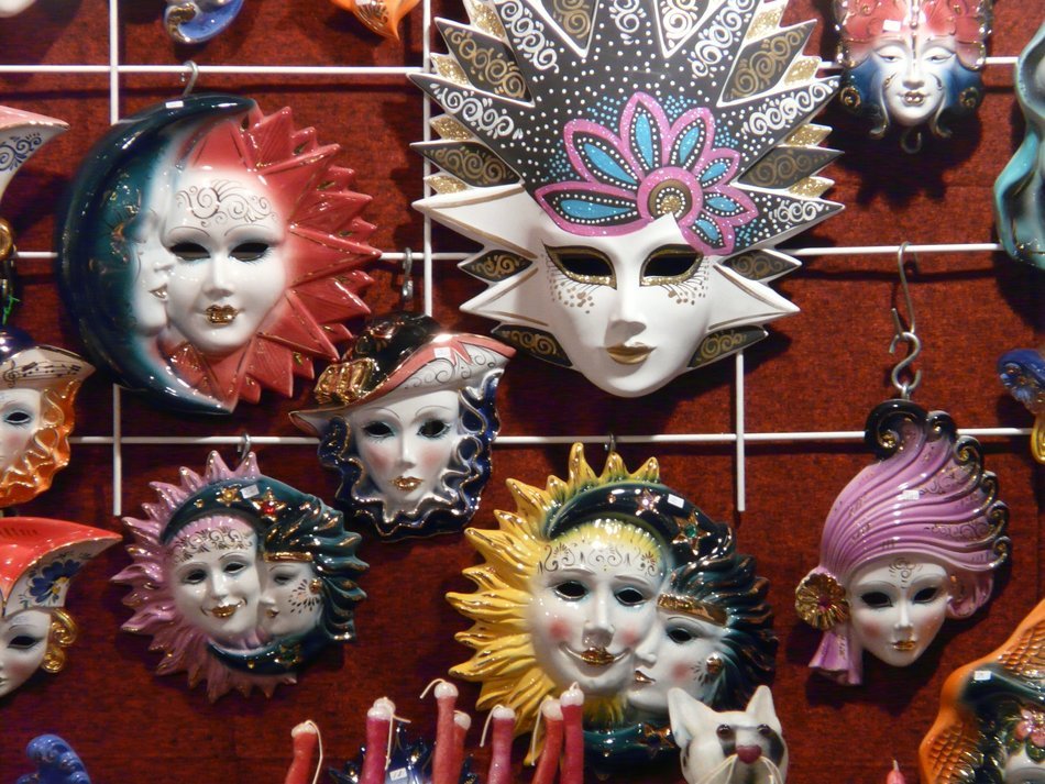 variety of carnival masks on stand