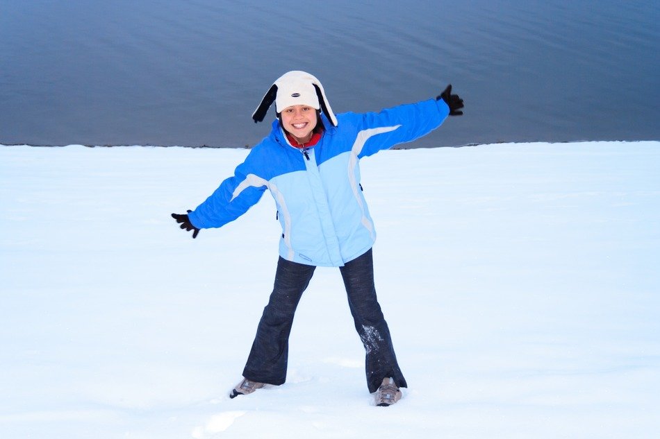 cheerful girl standing in the snow