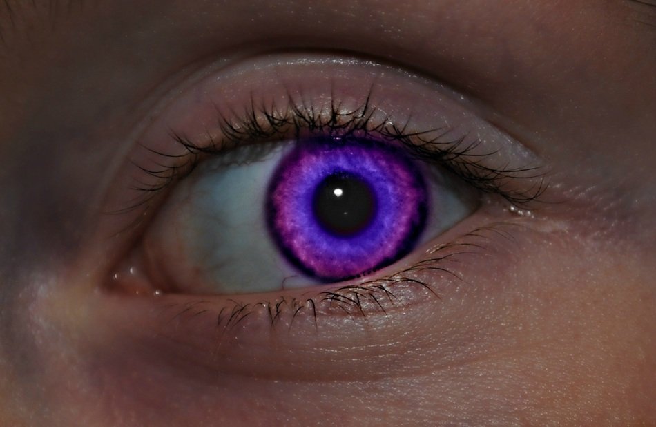 woman with bright purple eye close up