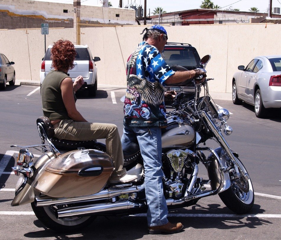 man with woman on a motorcycle harley davidson