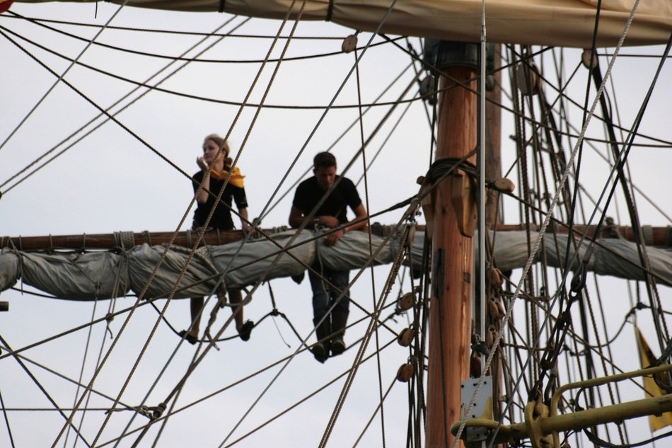 people on the mast of the ship