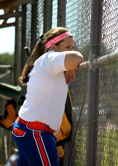 woman in sports at the fence