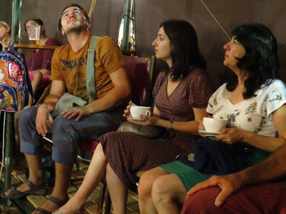 people with cups of tea
