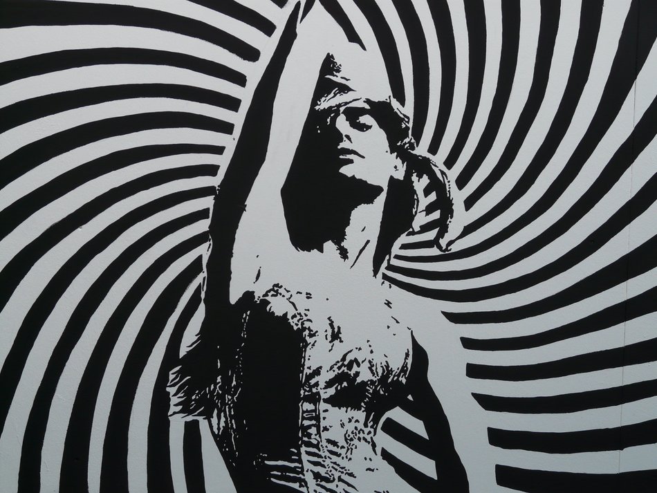 black and white photo of a woman on a striped background
