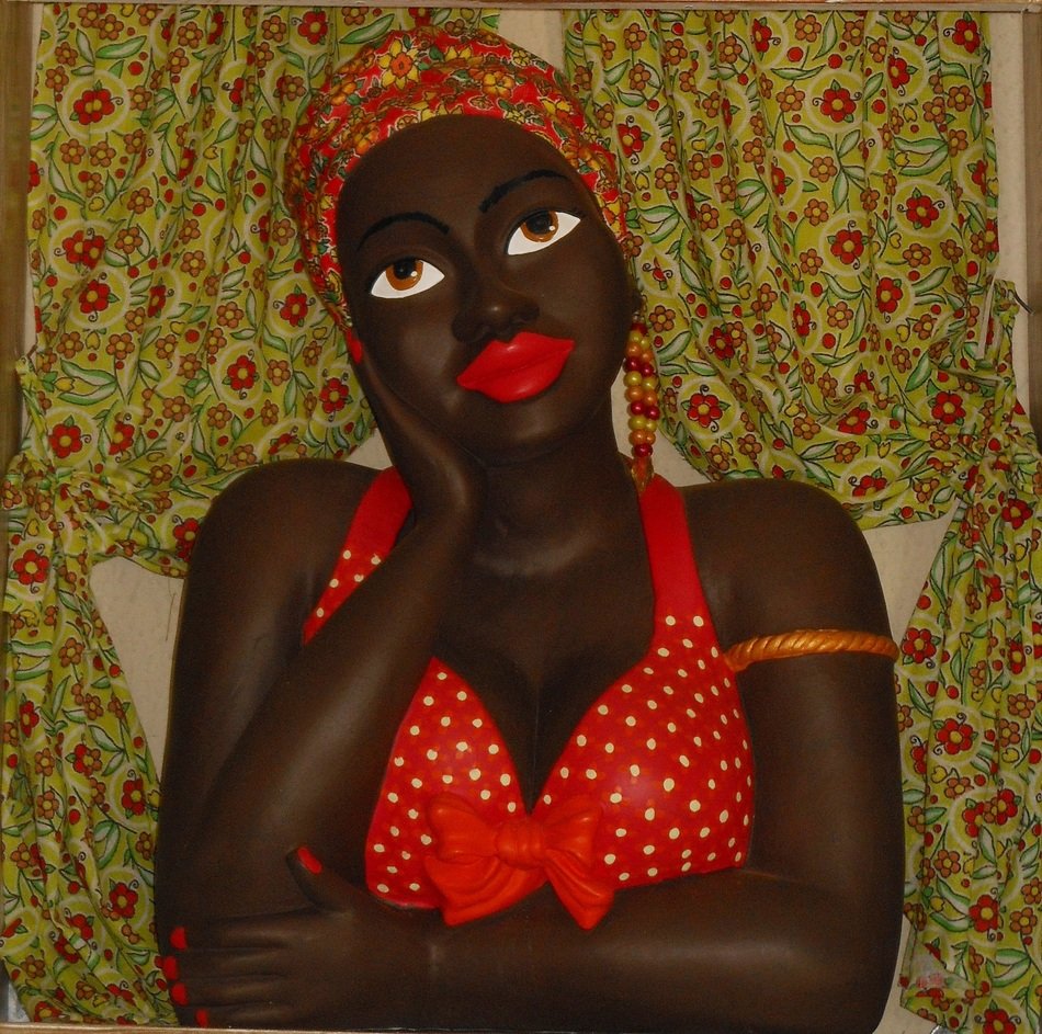 black doll statue in red bikini