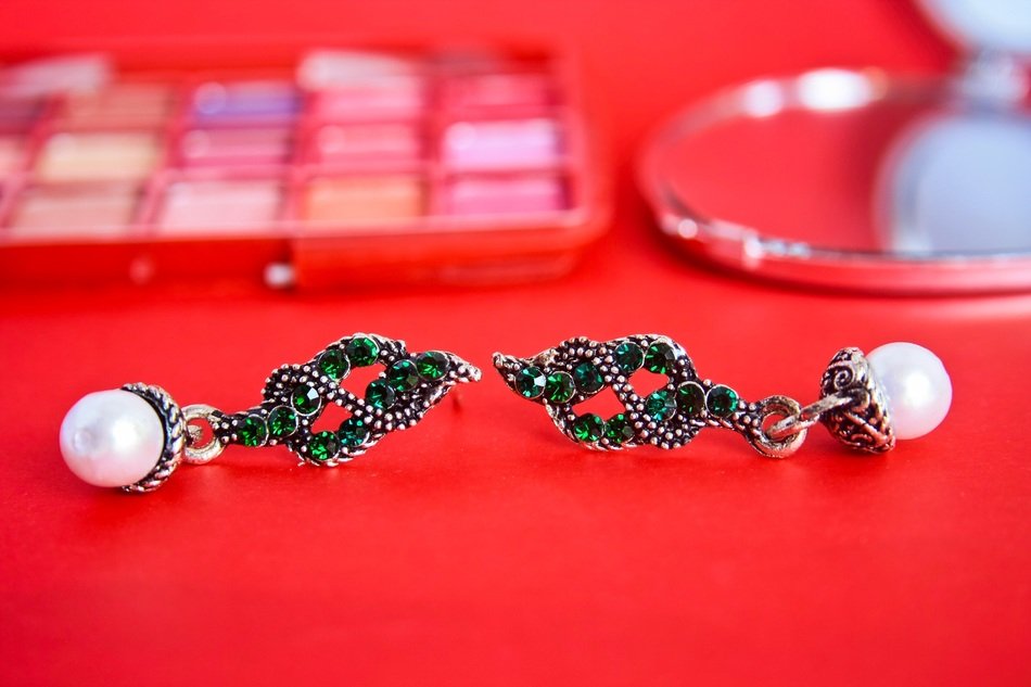 earrings on the red surface