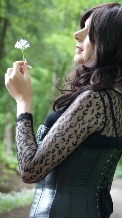 portrait of the happy woman with dandelion in the hands