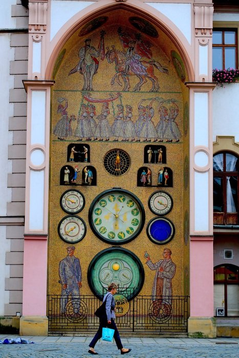 the woman walked about clock monument in czech