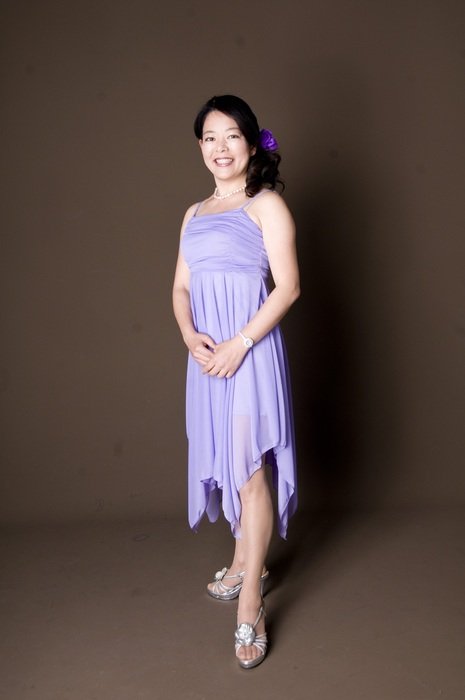 smiling brunette in purple dress