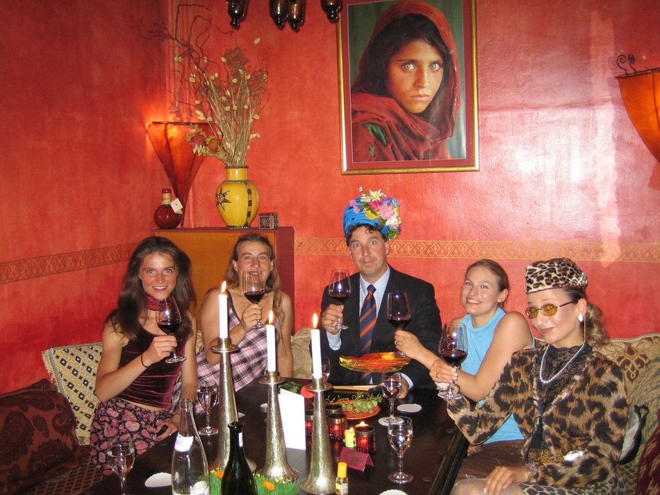 company in oriental costumes in a restaurant to celebrate