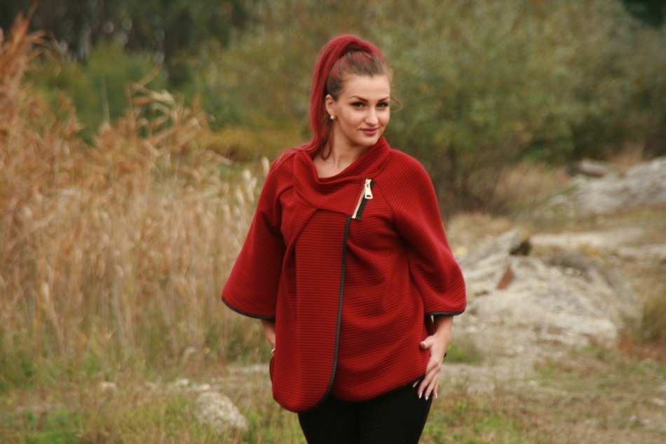 Model with long red hair among nature