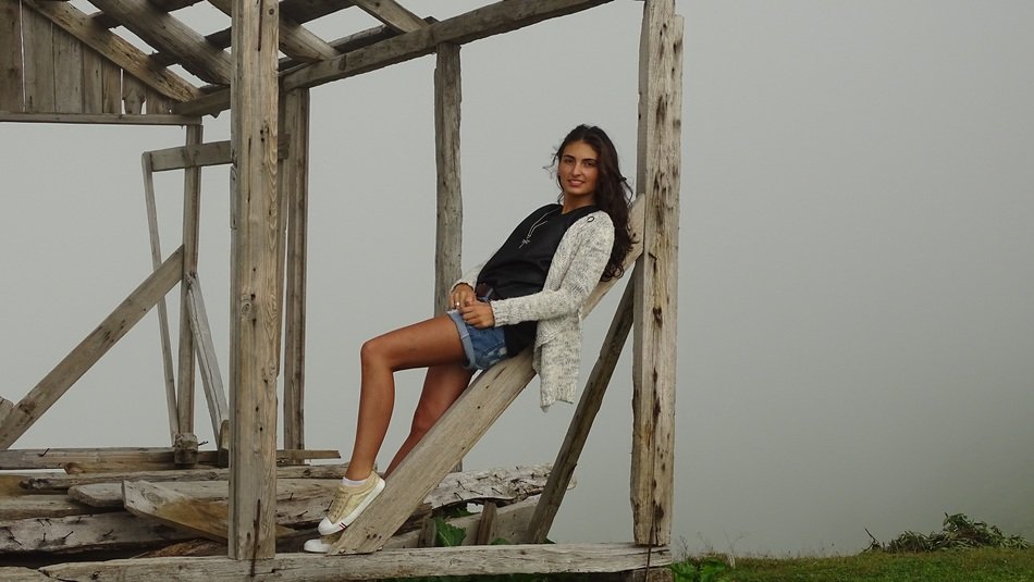 girl posing on wooden beams