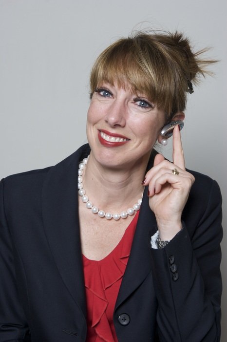 portrait of a business woman touching an earphone