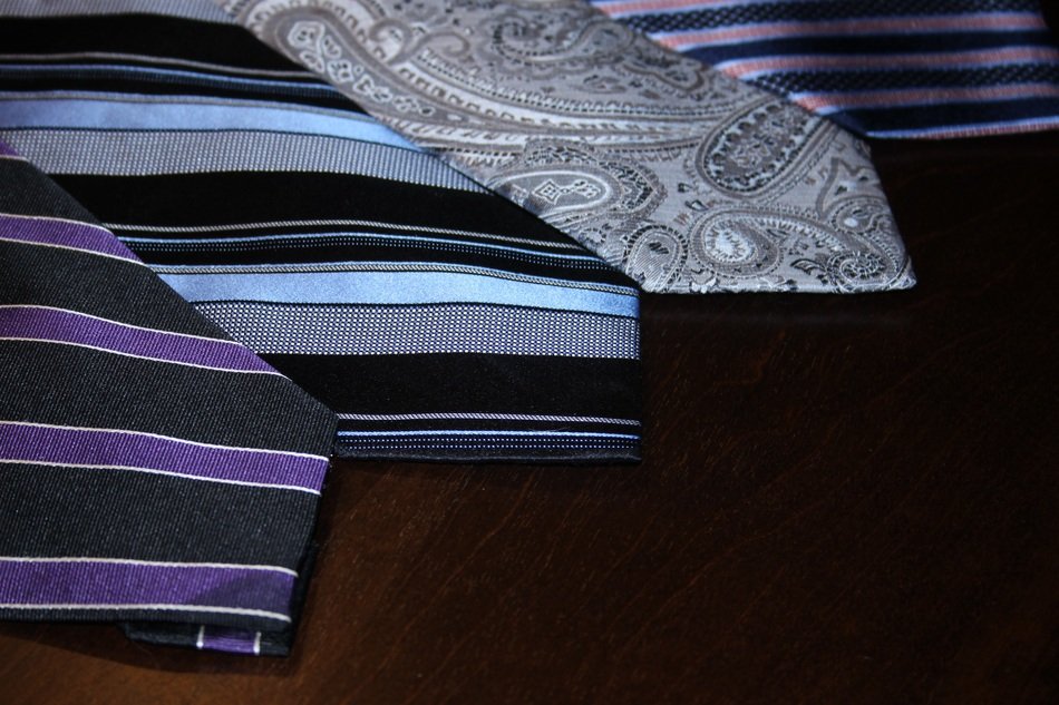 differently paterned neckties in a neat pile