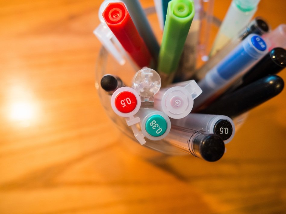 pens in the stand on the desk