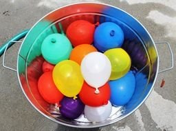 colorful Balloons filled with water in bucket