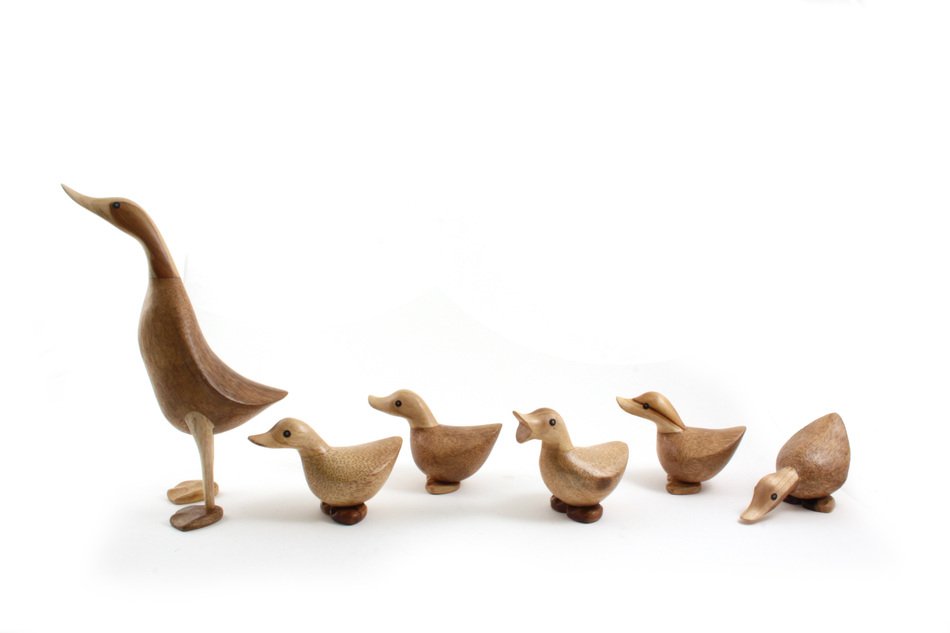wooden duck figures with ducklings