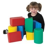 little girl sitting near colored cubes
