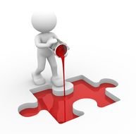 figurine of a person fills a piece of a puzzle with paint