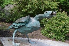 bird like a sculpture on a stone