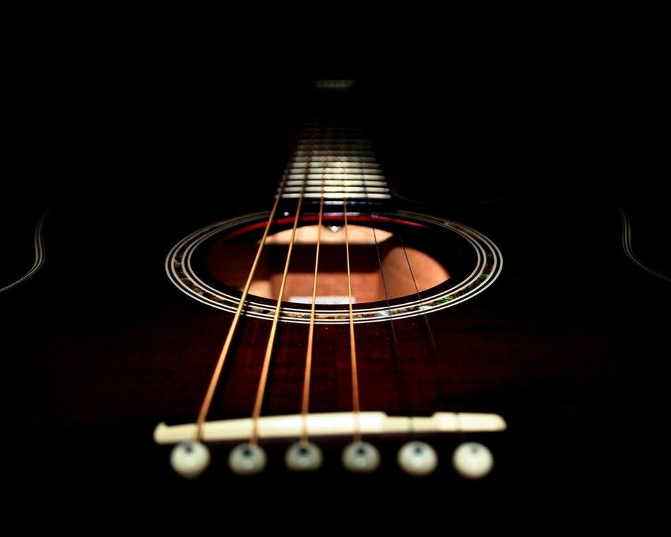 guitar strings under the light of a lamp