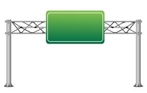 green road sign over highway