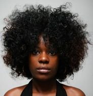dark-skinned girl with curly hair