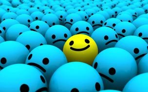yellow emoticon among blue emoticons