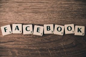 composing the word facebook from letters on the wooden surface