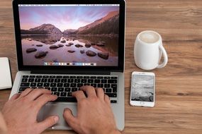 Human hands on a laptop keyboard