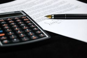 calculator and documents with pen