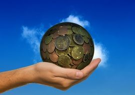 hand holding money ball