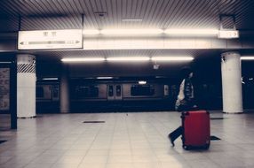 man with suitcase in subway