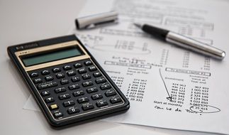 calculator and bank statement on the table