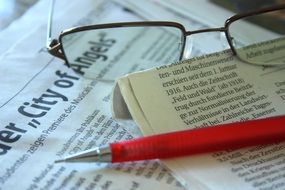 business newspaper and pen